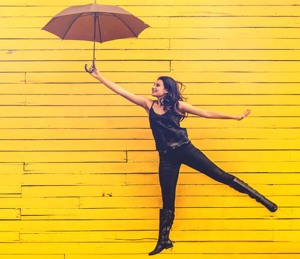 How to be bold and confident. Happy umbrella girl jumping. Blog article by RebeccaRoberts.com