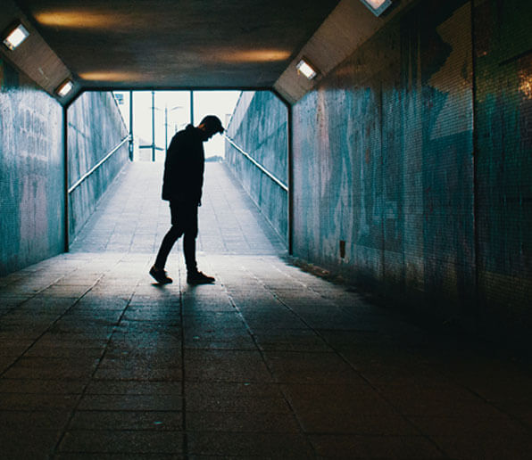 I Feel So Alone - Taking a Second Look at What Shapes our Feelings - Man standing in a lonely corridor Blog article by RebeccaRoberts.com